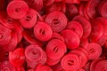 Heap of red strawberry licorice wheels swirl shape candies at supermarket. Creative sweet food confectionery pattern. Kids treats
