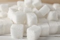 Heap of refined sugar cubes on table, closeup Royalty Free Stock Photo