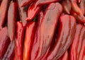 Heap of ripe big red peppers at a street market. A large number of red peppers in a pile.