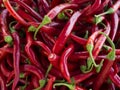 Heap of ripe big red peppers at a street market. A large number of red peppers in a pile. A special variety of red peppers.