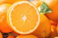 Heap of Ripe Organic Oranges at Farmers Market. One Fruit Cut in Half with Visible Texture Bright Vibrant Color. Vitamis Superfood Royalty Free Stock Photo