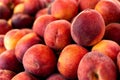 A heap of ripe red peaches at market. Background.