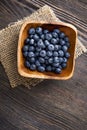 heap ripe sweet blueberries on wooden table top view