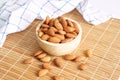 Heap of roasted almonds in brown wooden bowl. Royalty Free Stock Photo