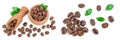 Heap of roasted coffee beans in wooden bowl with leaves isolated on white background with full depth of field. Top view Royalty Free Stock Photo