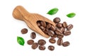 Heap of roasted coffee beans in wooden scoop with leaves isolated on white background with clipping path and full depth Royalty Free Stock Photo