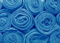Heap of rolled up blue colored blankets, for background Royalty Free Stock Photo