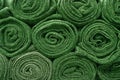 Heap of rolled up olive green blankets for background Royalty Free Stock Photo
