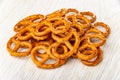 Heap of salted pretzels on wooden table Royalty Free Stock Photo