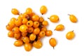 Heap of sea buckthorn and scattered close-up on a white background