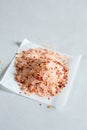 A heap of sea salt with chilli flakes on piece of paper Royalty Free Stock Photo