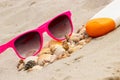 Seasonal concept. heap of shells, sunglasses and sun lotion. Protection from sun Royalty Free Stock Photo