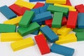 Heap of colorful wooden building blocks are lying in a white studio Royalty Free Stock Photo