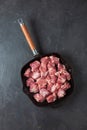 Heap small pieces raw meat in frying pan