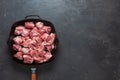 Heap small pieces raw meat in frying pan top view