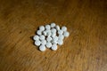 Heap of small white vitamin K2 tablets Royalty Free Stock Photo