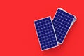 Heap of solar panels on red background. Global ecological trend. Green, alternative form of energy