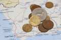 Heap of South African Rand coin money on on the map. Concept of finance or travel