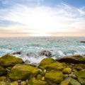 heap of stones on emerald sea coast at the sunset Royalty Free Stock Photo