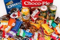 Heap of sweet snacks and drink jars on the table. Oreo, Choco-Pie, Ritter Sport, Haribo, Chupa Cups, YumEarth, Sanpellegrino,