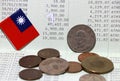 Heap of Taiwan dollars coin money and mini Taiwan flag on the book bank. Concept of Saving money