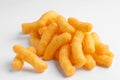 Heap of tasty cheesy corn puffs on white background, closeup Royalty Free Stock Photo