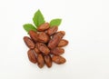 Heap of tasty dry dates or dates palm or palm phoenix dactylifera fruit with green leaves isolate on a white backdrop. Royalty Free Stock Photo