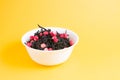 heap of tea with dried strawberries in a small white bowl Royalty Free Stock Photo