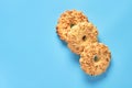 Heap of three fresh circle oat cookies with hole and peanuts lies on blue desk on kitchen. Space for text