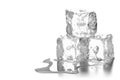 Heap of three melting ice cubes with water and reflection Royalty Free Stock Photo
