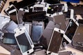 A heap of the top covers with displays of broken mobile phones