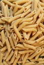 Heap of Uncooked Dried Whole Wheat Penne Rigate Pasta Royalty Free Stock Photo