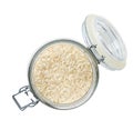 Heap of uncooked long rice basmati grains in glass storage jar isolated on white background top view