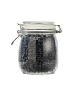 Heap of uncooked black beans grains in glass storage jar isolated on white background Royalty Free Stock Photo