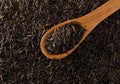 Heap of uncooked, raw, black wild rice grains in wooden scoop on rice grain background, flat lay top view from above Royalty Free Stock Photo