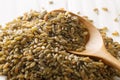 Heap of uncooked, raw freekeh or firik, roasted wheat grain, in wooden spoon Royalty Free Stock Photo