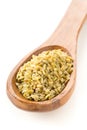 Heap of uncooked, raw freekeh or firik, roasted wheat grain, in wooden spoon over white Royalty Free Stock Photo