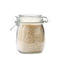 Heap of uncooked wild long rice basmati grains in glass storage jar isolated on white background
