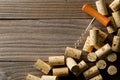 Heap of unused, new, brown natural wine corks with corkscrew on