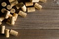 Heap of unused, new, brown natural wine corks on wooden board, f