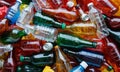 Heap of used empty multicolor plastic bottles and aluminum cans, close-up background, separate waste collection Royalty Free Stock Photo