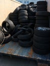 Heap of used tires inside a container