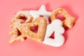 Heap of various festive christmas cookie on pink background