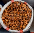 Heap of very dried apricots in bag on fair