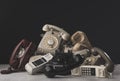 Heap of vintage telephones and receivers