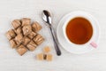 Heap of wafers with filling, teaspoon, sugar cubes and tea Royalty Free Stock Photo