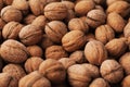 Heap of walnuts in a shell, pile of nuts background. Royalty Free Stock Photo