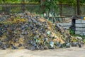 Heap of waste garbage dump with pots and leaves of dried plants in rural areas of agro-industrial complex