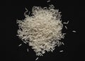 Heap of white basmati rice on black background. Flat lay