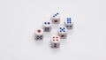 Heap of white cubic dice with blue and red spikes dots on a white background. Royalty Free Stock Photo